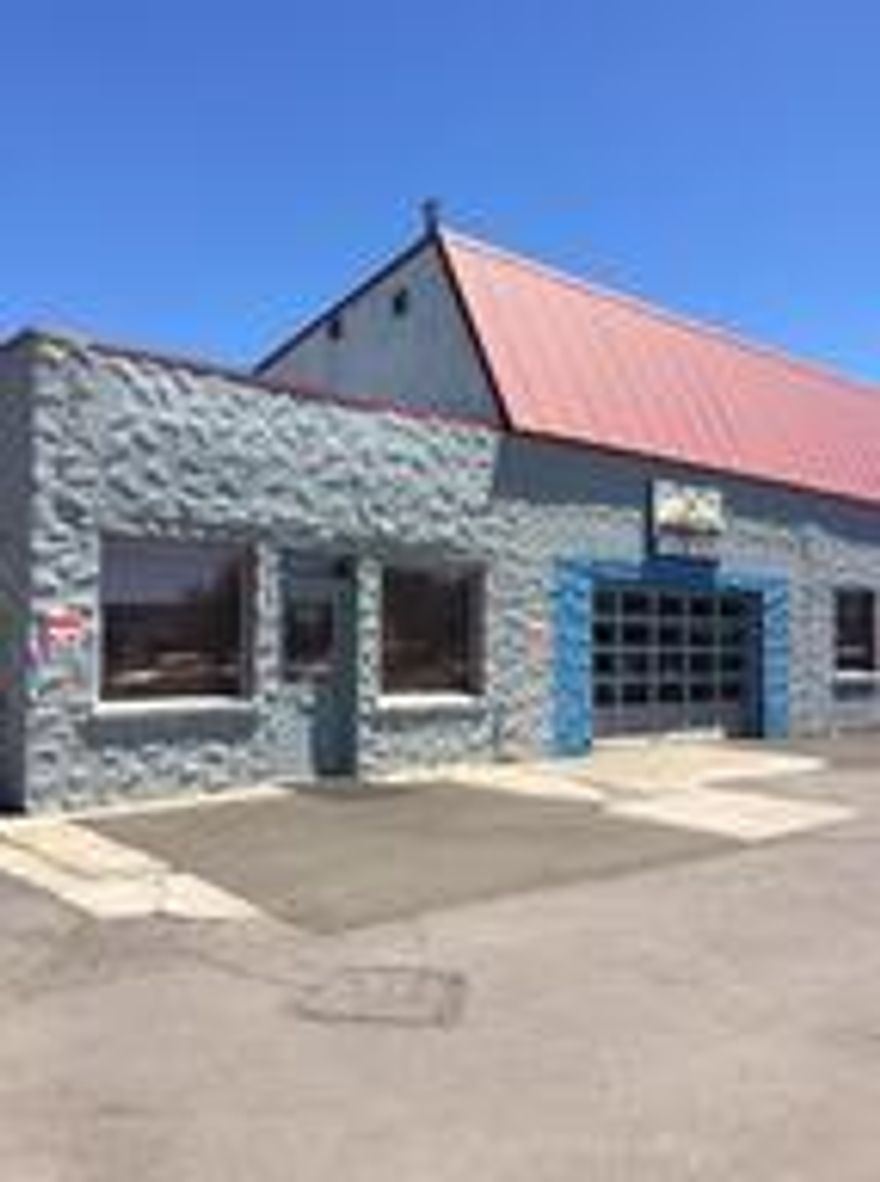2878 sq. ft. building with office/reception area, 1/2 bath and large warehouse area which can hold about 6 cars.  Paved parking for 10-12 cars.  Tenant to pay own utilities.  Building suitable for a variety of uses.