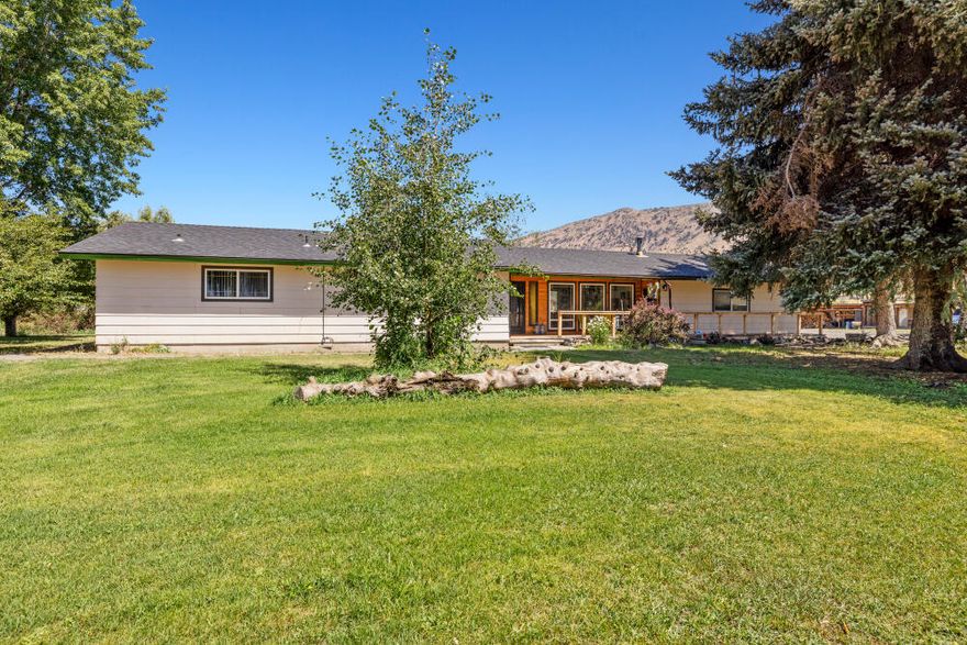 Make this haven on the Lost River your home! Allow cool afternoon breezes to whisk you away to a peaceful retreat on this 4.30-acre hobby farm. Big shade trees, beautiful flower gardens and the perfect little greenhouse are just the start of this must-see property. The large +/-50'X46' shop was built to accommodate log trucks and boasts a reinforced 3' deep concrete slab. Unique to this property, KID irrigation rights for 3.51 acres are at the end of the ditch and allow for maximum usage.441' of river frontage allow you year-round access for fishing,swimming,kataking,etc.Inside the home,enjoy oversized picture windows w/ custom tongue & groove finishes in the family room,a cozy certified woodstove,newer roof & tons of potential to make the space exactly what you want. Attached 2 car garage.Plenty of trailer or RV parking w/ 50amp hook ups, 6 frost free hydrants on 1.5HP pump, raised garden beds and chicken coop top off this desirable property.