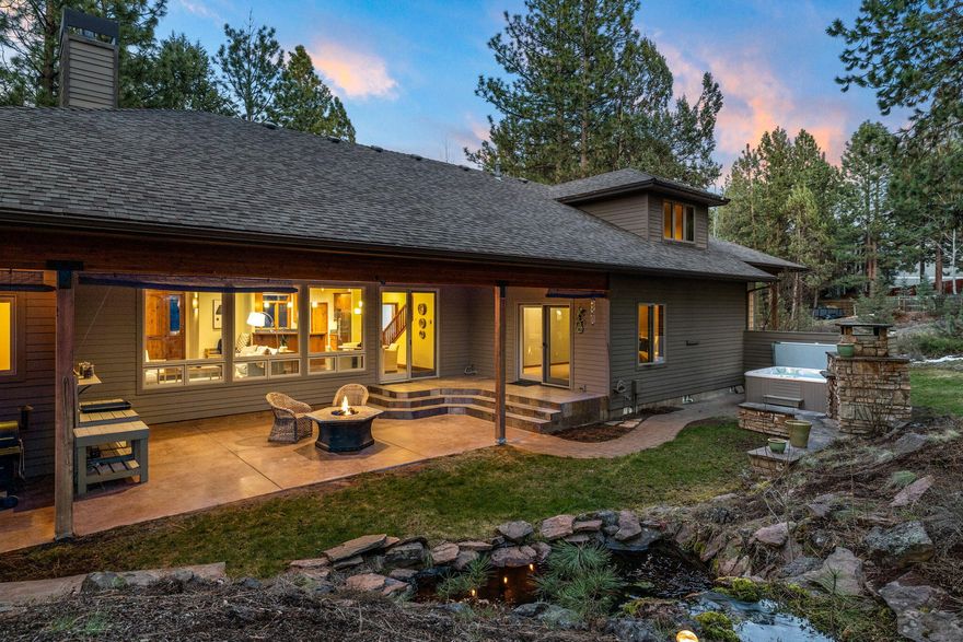 Entertainer's Paradise! Step into the enchanting lifestyle of this remarkable home offering seamless indoor/outdoor living and main-level living convenience. Upstairs, discover a versatile bonus room with an additional office space.  The expansive backyard oasis is complete with a large covered patio, ideal for year-round entertaining. Revel in the tranquil ambiance enhanced by a beautiful water feature, outdoor fireplace, and indulgent hot tub, offering the perfect setting to unwind and savor the surrounding wildlife. Store all of your toys in this 3 car garage with an oversized bay.  Nestled within a gated community, this home enjoys a prime location close to dining options in NorthWest Crossing and just a short distance from downtown, offering convenience without sacrificing tranquility.