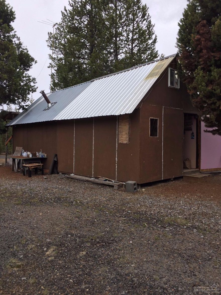 Great property backs up to Forest land. Rustic hunters cabin with 3 RV hook ups available. Nice shop to store the toys. 1 acre lot next door is available at an additional cost. Tons of trails for horseback riding, quading, snowmobiling, or hunting, right from your own lot! This cabin was not permitted. Insulated panels can be removed then you have a covered deck area for playing cards on those summer nights.