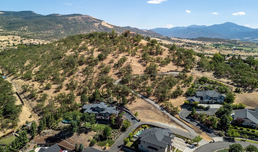 Build your dream home, instead of buying someone else's! This stunning 1.63 acre view lot in the sought-after Crystal Heights subdivision. You are going to love the 180 agree views of the Valley and Surrounding mountains including Table Rocks. The lot offers privacy and is moderately sloped offering a lot of potential. One of the final vacant land parcels in this neighborhood. The lot is surrounded by other estate properties. All public utilities to the street.  The driveway and potential building pad are now in place and the lot is ready for you and your builder. Owner may consider carrying.