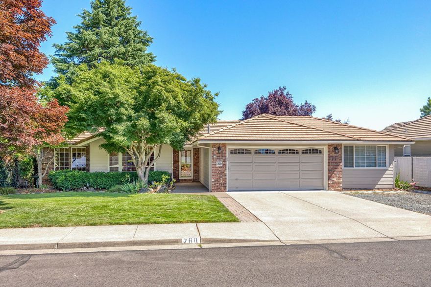 Meticulously maintained single level home in sought-after Jackson Creek Estates!  Featuring vaulted ceilings, tile roof, great floor plan w/2 living areas—perfect for gatherings. The family rm features cozy gas fireplace & French doors that open to a beautifully landscaped backyard w/mature shade trees, roses, hydrangeas, garden beds, blueberry bushes, fig tree & stone path leading to a garden shed that could also serve as a playhouse. The Trex deck offers a lovely space to gather & enjoy meals outdoors. Updated kitchen w/Corian counters, newer appliances & cheerful breakfast nook that enjoys backyard views. Spacious primary suite w/extra large walk-in closet & completely remodeled bath. Guest bath is light filled w/skylight. Extras include hardwood flooring, updated lighting, central vac, attic storage & don't miss the FULL BAY workshop area w/shelving & 220V. RV pkg in the front w/flagpole. Fresh exterior paint (~5 yrs ago) & recent interior paint. This is where quality & value meet