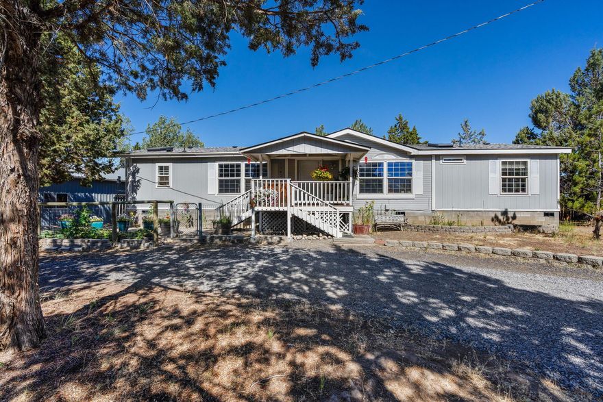 **Inviting** 3-bedroom, 2-bath home set on 2.1 fenced acres, just minutes from downtown amenities. Spanning 1848 sq ft, this property features a well-designed floor plan with the master suite strategically placed for privacy. Enjoy the expansive living space filled with natural light from skylights, perfect for gatherings or relaxation. The large kitchen offers abundant storage for culinary enthusiasts, while the sizable primary bedroom includes a walk-in closet. Step outside to a covered back patio overlooking a serene pond, ideal for entertaining or quiet evenings. The 24x40 garage/shop provides ample space for hobbies or storage needs.Brand New roof installed. With nearby parks, schools, and shopping, this home blends peaceful living with convenient access to town. Don't miss the chance to make this charming property your own!