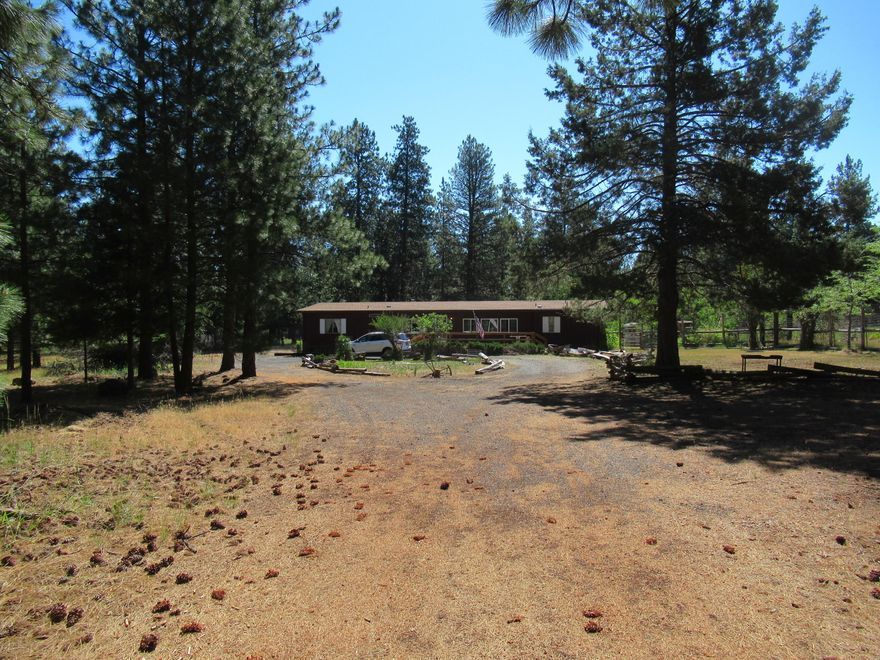 Hidden gem horse property on nearly 2 acres of forest land, set back off the road for added privacy. Keno, Oregon, is a desirable community, and this 1980 manufactured home has a lot to offer with 1848 sq. ft., 3 bedrooms, 2 bathrooms, including a spacious primary with a large closet. The open floor plan features generous living areas, ample kitchen space, a large pantry, a large laundry room with a wash basin, a separate entrance, and potential for office use. Outside, you will find durable containment fencing for livestock, 2 separate pastures, a fenced garden, greenhouse, multiple storage sheds, RV Dump, & several spigots for easy watering. Enjoy mature orchard trees, 3 apples, 2 pears, 2 plums, & Apricot. There is plenty of room to park all your toys with a circular driveway for easy exit. This is a must-see and priced to sell quickly. Don't miss the opportunity to own a property where comfort, care, and potential come together. This property is ready to welcome you home.