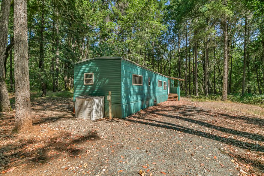Come Check out this prime property with a 1974 single wide mobile home holding the site for you to build your dream home. The property is centrally located south of
Grants Pass, tucked away in a wooded area with mature Madrone and Pine trees. Your future home awaits you with plenty of space featuring 2.50 acres with a storage
shed, a great producing well per seller and a standard septic system. The mobile home was updated with heating and cooling, new flooring, interior and exterior paint, and
new lighting fixtures, and new kitchen countertops.
Due to the age of the home this will need to be a Cash transaction or a new construction loan only. Buyer to do their own due diligence.