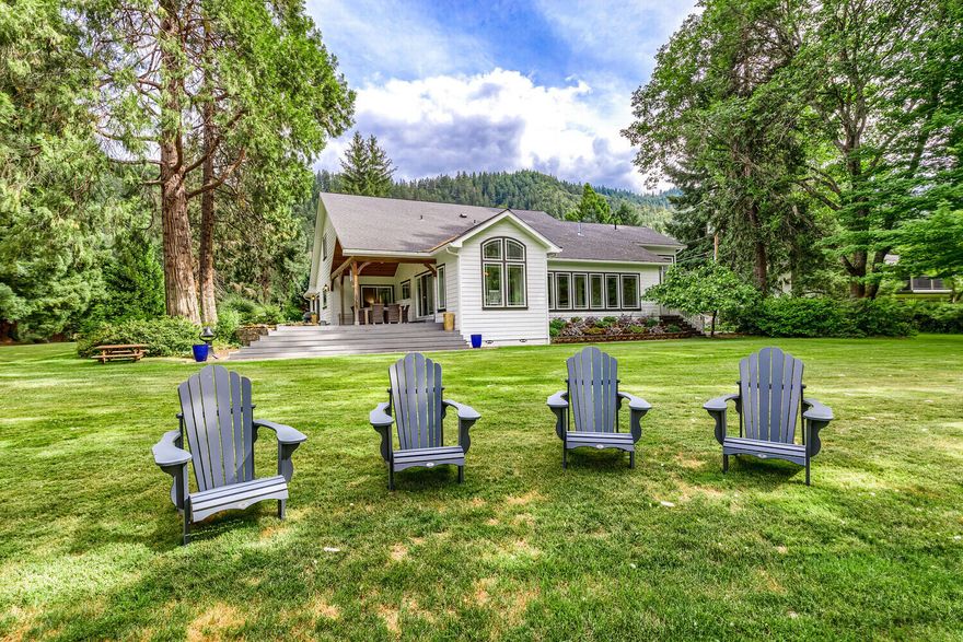 Rogue River frontage & park-like grounds surround this lovely 3600+ s/f home which has been remodeled from the ground up with high quality details throughout. The inviting foyer leads to an elegant great room with fireplace & glass doors that open to a patio with covered deck overlooking the river. Guest wing with full bath also opens to the patio & takes in the wonderful river view. The exquisite kitchen will delight your chef & guests with high-end stainless appliances, marble counters and custom cabinets. The kitchen opens to the dining room which is also surrounded by stunning views. Living room with fireplace and wall of windows facing the river leads to a half-story filled with the luxurious master suite appointed with large walk-in closet, custom tile shower & soaking tub. The upper floor is used as office, 3rd bedroom & media room. This extraordinary property has 2-car garage, workshop, storage areas, RV parking, paved drive & irrigation from the Rogue River on 1.62 lush acres