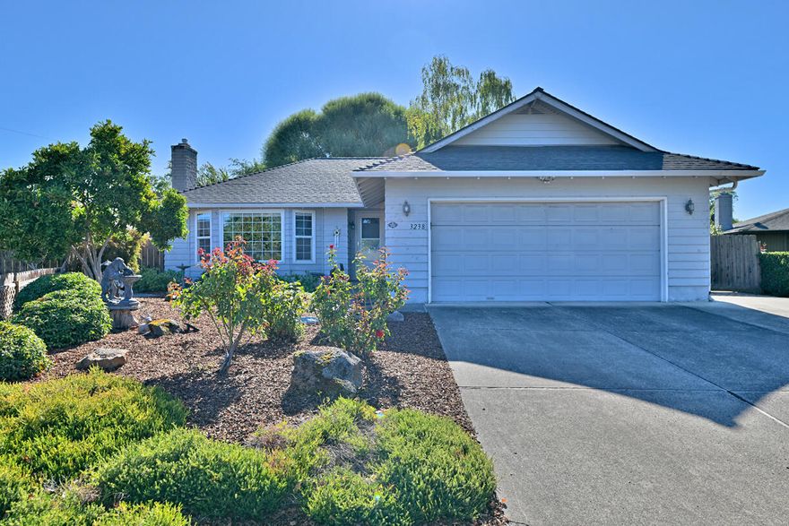 Lovely East Medford home ideally located near shopping, schools, and all amenities! Tucked back from the street in an established neighborhood, this charming property offers a generous third-acre lot with side-yard access for RV parking and potential for an additional dwelling unit. The light-filled one level, 1,400 sq ft floor plan features 3 spacious bedrooms and 2 full baths, a comfortable living room with a cozy gas fireplace, and an open kitchen with Corian countertops and stainless-steel appliances. Enjoy outdoor living in the beautifully landscaped backyard with a covered porch and patio—perfect for entertaining. Plenty of space and zoning to build your she-shed or mancave.  Drip systems in back and front, mature trees, hardscape accents, two storage sheds and plenty of space for gardening or recreation complete the picture. With ample parking and inviting curb appeal, this East Medford gem combines comfort, functionality, and future potential in one exceptional property.