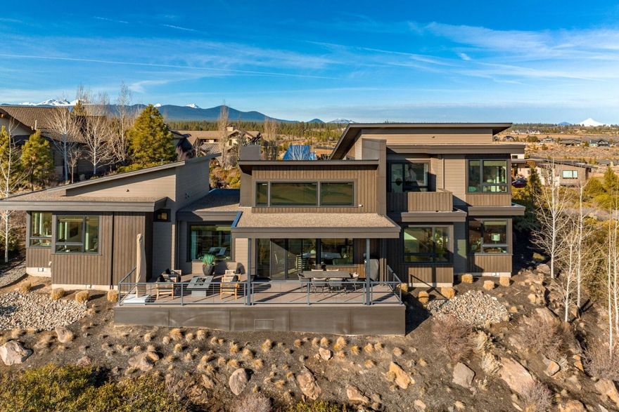 Nestled on a half acre ridge overlooking the golf course in the heart of Tetherow, this Timberline Construction home embraces and connects to the beauty of its surroundings. Every detail of this home's design is beautiful and functional, boasting clean lines, warm details, pristine finishes and an abundance of expansive windows. Situated overlooking the 8th fairway, with a main level primary & office, this residence features a harmonious connection with nature and light. The culinary enthusiast will appreciate the well-appointed kitchen, perfect for entertaining or cozy dinners. With three spacious bedrooms, a private office, a bonus room, multiple outdoor living spaces, and a sitting room, this home offers versatility and privacy for gathering and relaxation. This extraordinary property is a sanctuary where contemporary design meets tranquility and functionality.