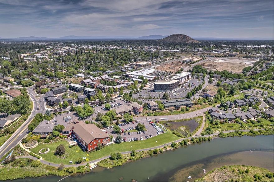 Experience the ultimate urban lifestyle at Basecamp: Bend's sought-after community of modern townhomes featuring stunning architectural design and an outdoor enthusiast's dream location. Situated in the heart of Bend just one block to the Deschutes River & steps to the Old Mill District & all Downtown amenities, this thoughtfully-designed END UNIT offers 3BR/3BA PLUS a legal 1BR/1BA ADU. Exquisite light-filled Great Rm w/floor-to-ceiling windows, warm wood accents & access to covered deck. Chef's Kitchen offers Quartz countertops, extensive working isl, sleek subway backsplash, & stainless appl. Dining area, 2nd sitting rm & full BA on main. Upstairs: Primary Suite w/walk-in closet & spa-like BA w/dual vanity & tiled shower. 2 additional BR + full BA & loft flex space. Ground level ADU w/separate entrance is an excellent income generator or fantastic home office space. 2 car attached garage for all your Bend gear. Delightful community grill, fire pit & common area to enjoy year-round.