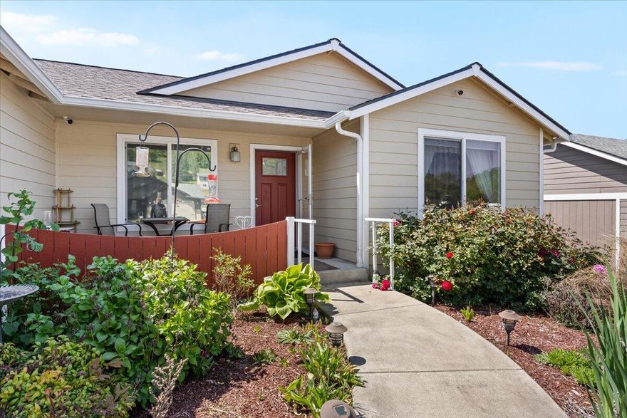Located in Myrtle Creek, Oregon, this newer-built single-family home offers a comfortable and modern living experience. The residence features three spacious bedrooms and two full bathrooms. The master suite is a highlight, boasting a walk-in closet and a private bathroom, providing a serene retreat within the home. The open-concept living area is designed for both functionality and style. The kitchen is equipped with a central island, offering additional counter space and seating options—perfect for casual dining or entertaining guests. All major appliances are included, making this home move-in ready. Adjacent to the kitchen, the dining area provides a cozy space for family meals. Step outside to enjoy the beautifully landscaped yard. The backyard features a patio area, ideal for outdoor gatherings or simply relaxing in the fresh air. At the front of the house, a quaint porch adds to the home's curb appeal and offers a welcoming entrance.