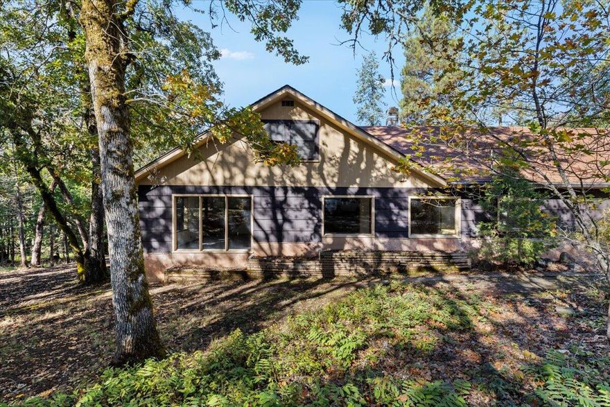 Check out the potential in this classic 1957 home on 1.34 acres, just a few minutes from downtown Grants Pass. Inside, you'll find 5 bedrooms and 2 bathrooms spread across nearly 2,900 square feet, giving you tons of space to spread out. There's a roomy family area, a cozy living room, and a separate dining space perfect for gatherings. The breakfast nook is great for casual mornings, and there's even a bonus room that can be turned into an office, playroom, or hobby space.
Step outside to a large deck overlooking your large backyard with seasonal creek—an ideal spot to relax and enjoy the peaceful setting. The property also includes a large outbuilding that could be used for storage, a workshop, or your next creative project. With plenty of room for animals, gardening, or outdoor fun, this property has endless potential. Call your Realtor to see it today!!