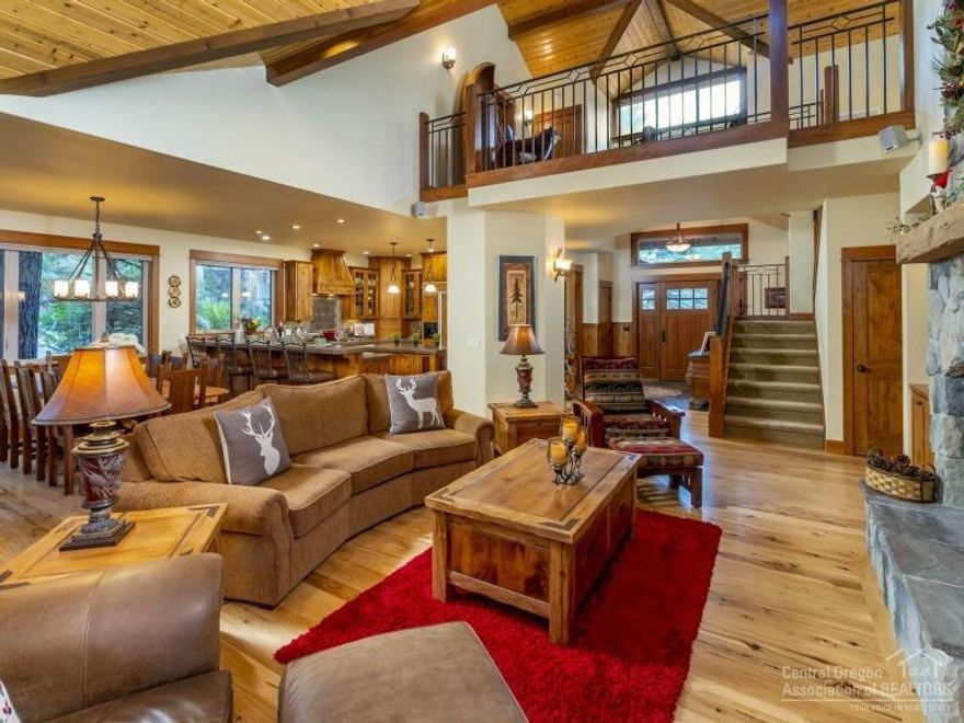 Distinctive Sunriver retreat. Exceptional quality and high-end finishes add rustic elegance including vaulted Knotty-Pine ceiling, exposed beams, abundant wood-clad windows, gleaming Hickory floors, Knotty-Alder cabinetry and impressive floor-to-ceiling stone fireplace. Well-appointed 3323 sq. ft. of living space offering 4-bedrooms (3-master suites, one on main), 4.5-bathrooms, large bonus room, utility room, 3-car garage and enclosed backyard. North-end locale offers privacy and easy-access to amenities.