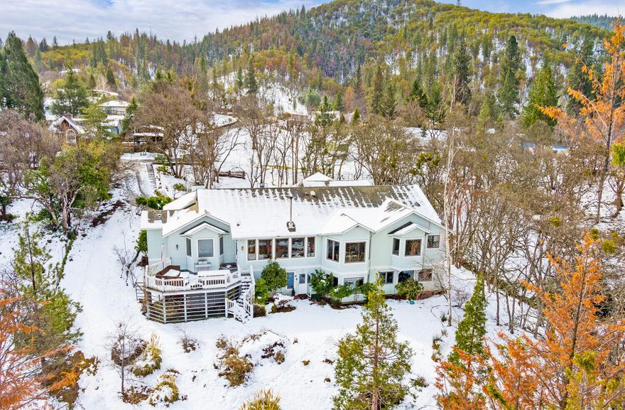 Rare opportunity to own a 4500+ square foot home on over an acre of gorgeous semi-flat land with TID irrigation in Ashland.  The moment you step into the home you are greeted with large windows to enjoy the territorial views within your own private oasis.  There is a den/office to the right of the front door with a gas fireplace and built-ins.  The living room has vaulted ceilings and an efficient, eco-friendly Blaze King wood-stove to keep the home toasty warm.  Kitchen has been tastefully updated with beautiful granite counter tops, an island and tons of storage.  There are 4 large bedrooms, all with their own bathrooms and two bonus rooms.  The primary bedroom has a stand-alone soaking tub, double vanity and shower that goes out to the hot tub on the private deck.  This home could also work for a two-family set-up with two of the bedroom suites downstairs, a mudroom, and another large family room.  The owner has made lovely improvements throughout the home.  This place has it all!