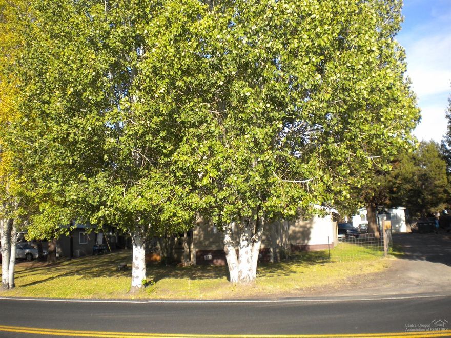 Completely set up operating manufactured home park with 5 homes owned by park. Fully rented, close to town and nicely laid out with landscaping and independent spaces allowing privacy for tenants. On City water and sewer, with individual electric meters. Keep As-Is or restructure with newer homes.