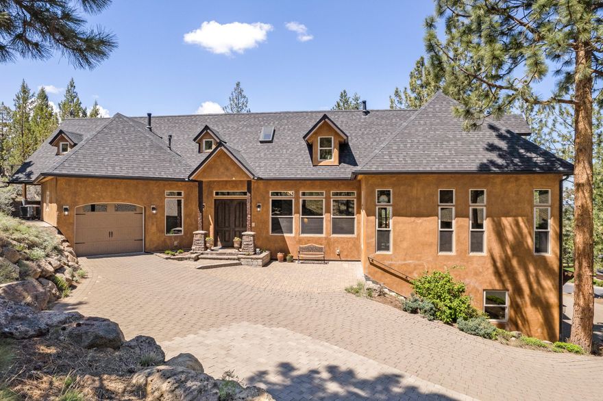 Introducing a stunning Italian-inspired masterpiece with captivating Cascade Mountain views. This 4 BD, 4.5 BA custom home spans 4,785 SF & features high-end finishes throughout. Enter to 13-14' ceilings, 8 ½' doors, elegant exposed beams, custom ironworks & 3 cast stone fireplaces. The entire home boasts custom tile travertine floors & baths, showcasing exquisite craftsmanship & attention to detail. The chef's kitchen incl's SS appl., granite counters & ample storage. The main level offers lovely decks overlooking mtns & forest (perfect for entertaining), along with the serene Primary Suite w/ stunning spa like bath & 2 walk in closets. Upstairs offers an addt'l en suite, spacious loft, bonus & BD. Enjoy the grand living room w/ floor-to-ceiling windows & views. Additionally, the lower level offers a 1,500-bottle mahogany wine cellar, a spacious garage, new roof, carpet & more.  Serene privacy completes this Italian-inspired gem. Immerse yourself in luxury, comfort & natural beauty.