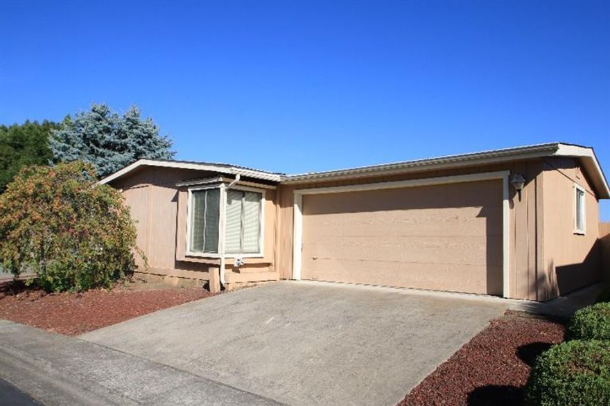 This is a wonderfully cared for home in one of the most popular 55+ manufactured home parks in the valley! This home has two large bedrooms and two baths, along with separate living and dining rooms and extra living space adjacent to the light and bright kitchen. The very private back yard has a nice, shaded patio. This wonderful park is located just minutes from the downtown Central Point area, with easy access to shopping and city services. The park also offers many extras including the wonderful rec center located just down the street form this home.