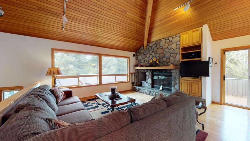 One of Sunriver's outstanding custom homes in a large, lovingly landscaped, private woodsy setting. Situated in the heart of Sunriver and close to all amenities, this beautiful reverse-living home on .64 acres features a wood-vaulted great room and kitchen upstairs, with a river rock fireplace and hardwood flooring, a powder room, and a large master bedroom that features a spa bathroom with a contemporary rain-shower and separate soaking tub. Skylights provide an abundance of natural light throughout. The downstairs suite features a second primary bedroom with in-suite bath, a third bedroom, a separate full bathroom, and a large family/media room, with direct access to a relaxing outdoor patio and hot tub. Turnkey ready with quality furniture for you to enjoy.