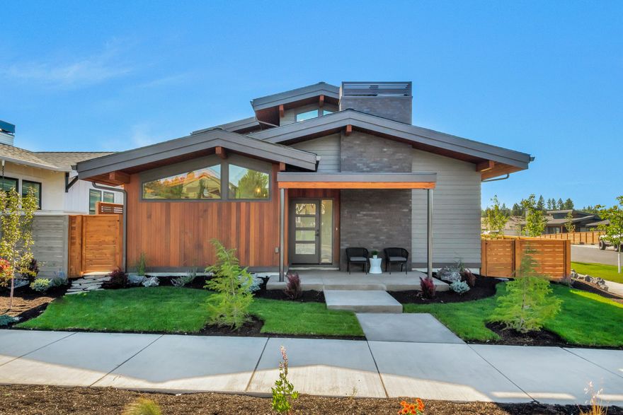 Stunning contemporary home in the coveted NorthWest Crossing neighborhood on Bend's westside. A luxurious and modern interior design with solid quartz countertops throughout, custom cabinetry, hardwood flooring and a spacious, open floor plan with vaulted ceilings. Floor to ceiling brick fireplace with live edge Acacia wood hearth adorns the great room along with the custom accent lighting adds to the aesthetic appeal. Main level resident suite with double vanity, heated tile floors and full tile shower. The corner lot offers abundant outdoor space to entertain and gather, as well and copious natural light penetrating the interior of the home for a warm and welcoming feel. High end energy efficient systems include a 98% efficient dual stage HVAC for heating/cooling, tankless water heater and photovoltaic solar array, offsetting recurring energy costs. Ideally situated near the central hub of NorthWest Crossing along with nearby schools, The Grove and Discovery Park.