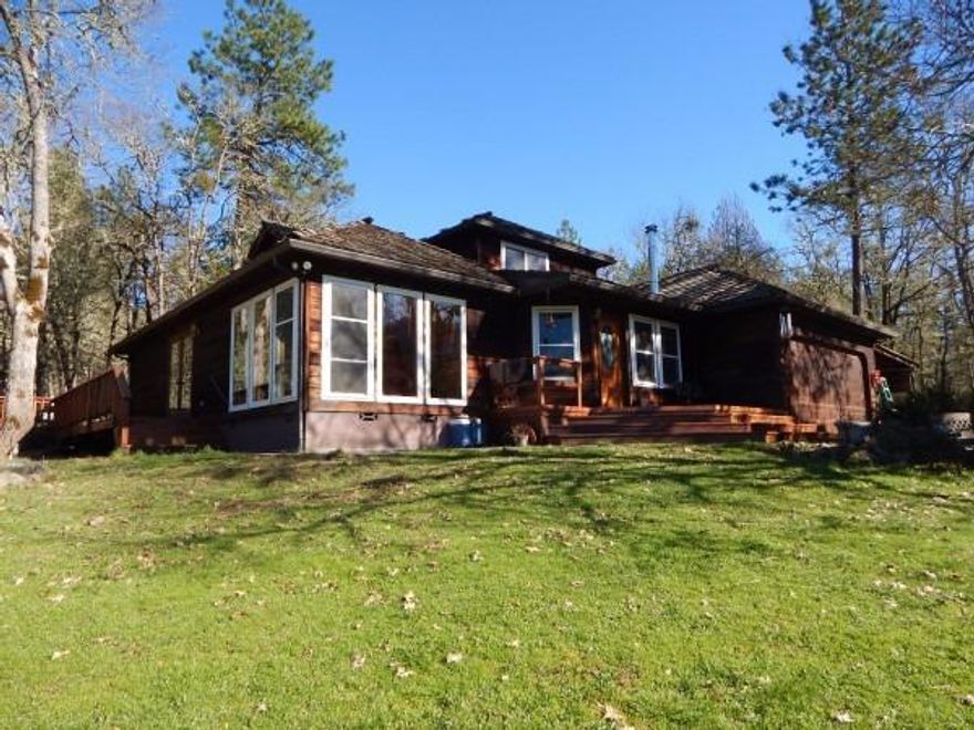 Amazing View! Sitting on 5 very usable acres this Wonderful custom cedar home was built in 1990 and features 3 bedrooms, 3 baths, approx.. 2178 sqft., 2 master bedrooms (one with a jetted tub), cozy family room w/wood stove, lots of windows for natural light, Red Oak wood-carpet & vinyl floors, laundry room w/sink and both the Kitchen and Dining area have French doors which open to a nice wraparound deck. There is a 2 car attached garage w/attached carport, RV parking, a green house, a detached shop and a barn w/loft. This glorious property is fully fenced w/gated entry, flat and usable. Garden to your heart's content, raise animals or just enjoy the setting! Located just minutes from town and down a private drive. New roof May 2016.