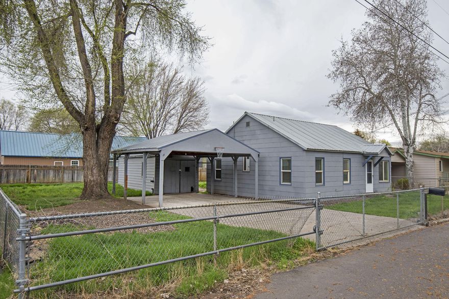 This old mill home is waiting for you to make it your own! Situated just across the street from a park and the Ochoco Creek, this single-level home has 3 bedrooms, 1 bath, spacious laundry/mud room with storage, a dining room and tons of opportunity. The larger city lot has its own well for irrigation, a single car garage/shop and a car port with room for two vehicles. The flat, fully-fenced lot has RV parking and is close to shopping, medical facilities, and the new Wild Ride food carts.