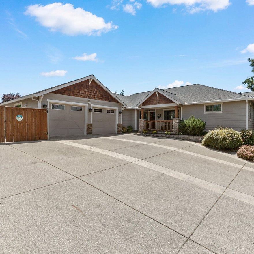 This one-of-a-kind custom home is a masterpiece located near Eagle Point golf course with mountain views. Step into a modern kitchen, with a gas range, built-in wine cooler, granite countertops, and an expansive kitchen bar. The 15ft deep walk-in pantry provides ample storage. A split floor plan grants privacy to the bedrooms. Open-concept kitchen and living room area create a seamless flow for gatherings while enjoying picturesque mountain views. Extensive primary offers tray ceilings, a cozy seating area, and a private deck. The en-suite bathroom is a true oasis, boasting heated floors and a custom walkaround tile shower. Never run out of space in the oversized two-car garage, shelving in the temp-controlled wine room, and find RV parking with full hookups/cleanout. The spacious covered outdoor living space is landscaped with flagstone and a water feature for relaxation. The property also presents exciting potential for an ADU, a full-size home, a pool, and even a workshop.