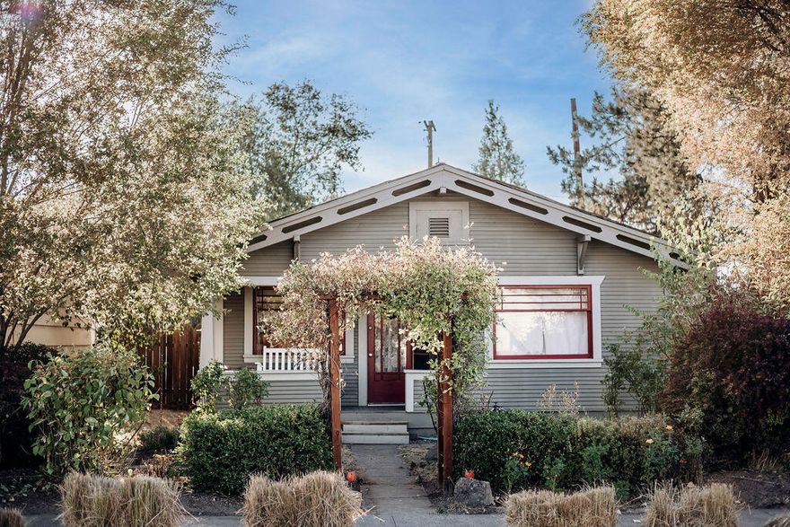 Don't miss this charming home in Downtown Redmond! This cozy home has been updated with hardwood floors, newer stainless steel appliances, and a gas fireplace. Imagine mornings on the porch swing, and full lush gardens that come alive in the spring! With an open floor plan and abundant natural light,  this home is low maintenance, and ready to call home. This home has 2 sheds, RV parking, off street parking, and alley access to the back yard.