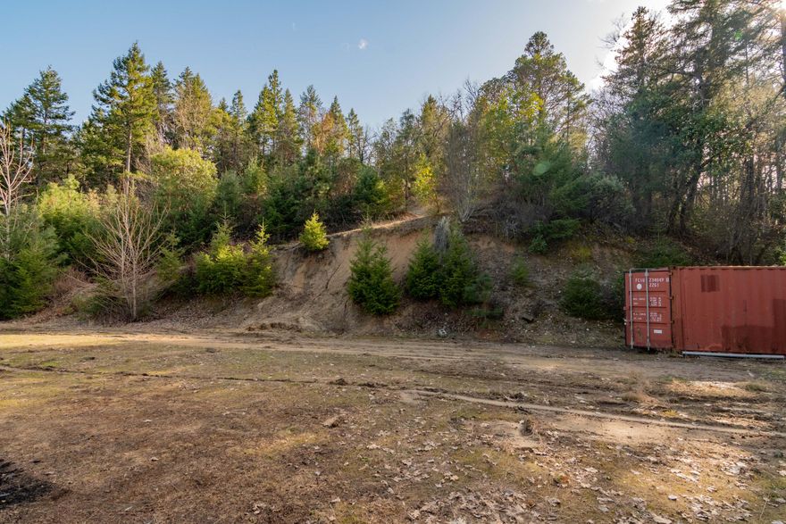 Have you been seeking a picturesque vacant lot with ample privacy and a multitude of possibilities? You're in luck! Nestled on a quiet cul-de-sac just 5.5-miles from Downtown Grants Pass, this 2.72-acre parcel delights the imagination with towering mature trees, a paved road, and lovely views. Conveniently situated just off of the well-traveled U.S. Route 199, the property features a paved road leading to two building pads. Power and well are already in with a 2,000-gallon holding tank. Get creative and build the home of your dreams on this rarely available, idyllic landscape. Whether you construct a classic log cabin, a modish retro ranch, or a rustic modern abode, the residence with be cheerfully engulfed in lush natural beauty. When you desire relaxation, the property is only moments from Apricity Vineyard, Applegate Saloon, and multiple trails. Call now to schedule your private showing!