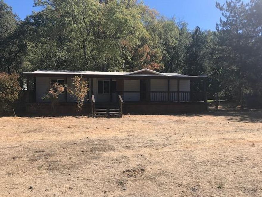 Live in beautiful Shady Cove and have your own little paradise on this parcel of land. Not too far from the river, or from town this flat acreage will be a great area to settle. Live in this humble abode or make it a place to build a new home with utilities close by. This property may qualify for Seller Financing (Vendee).