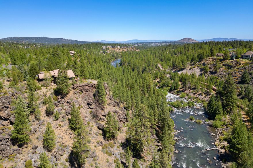 This stunning Mountain Modern home sits on one of Sunrise Village's premier riverfront lots. Perched on a .77-acre parcel that juts out over the Deschutes River rim, this custom residence is immersed in nature and privacy. Expansive windows frame stunning views and bring the outdoors in. Inside, enjoy 3 ensuite bedrooms—including a main-level primary with spa-like bath & walk-in closet. A second suite offers a private deck, bonus space, and potential for in-law living. The chef's kitchen, featuring a Sub-Zero refrigerator, Wolf range, & a custom island opens to the vaulted great room with spacious dining area w/custom wet bar. Extras include a spacious flex/office room, sunroom, sauna, heated floors in 4 of 5 baths, & solar hot water, 3-car garage w/utility sink and lg. storage room for all your gear. Sunrise Village is a gated community w/pool, clubhouse, tennis courts, & potential RV storage. Come fall in love with this exceptional home in a truly breathtaking riverfront setting!