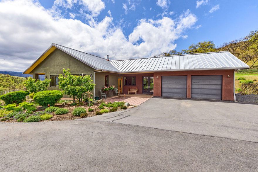 This one of a kind PEACEFUL RETREAT on 32.52 acres is a wildlife and bird lover's delight. The spacious, south facing, single level home has gorgeous views from just about every window of the vibrant open oak woodlands, grasslands, mountains and valley.  It was designed by an award winning architect for himself and shows quality in every way.  There is a 100 year metal roof, hardwood floors throughout, wood framed windows, a large, spacious office with separate entrance, covered front patio, two car garage, and RV parking. Ready for a variety of animals: cattle, horses or what the current owner has raised - miniature donkeys!  Solid barn, fenced and cross fenced, 22 acres with irrigation rights.  Horse riding trails nearby.  So quiet and private, surrounded by large parcels.  Sit in your living room and watch the  unexpected wildlife appear.  A nature lover's dream, and only about 5 miles to Ashland.