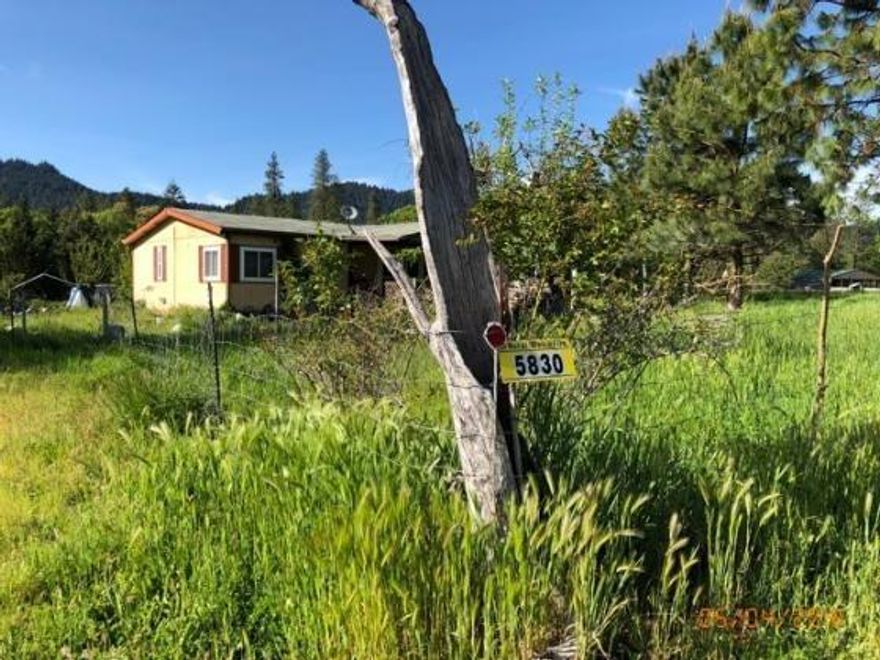 Beautiful piece of land just under 6 acres with views all around. Property has a 1988 double wide manufactured home and property is mostly fenced. A lot of area to garden. Great location to build a new home! All information is deemed reliable but not verified; anyone considering purchasing this property should perform their own investigation into the uses and condition of the property.