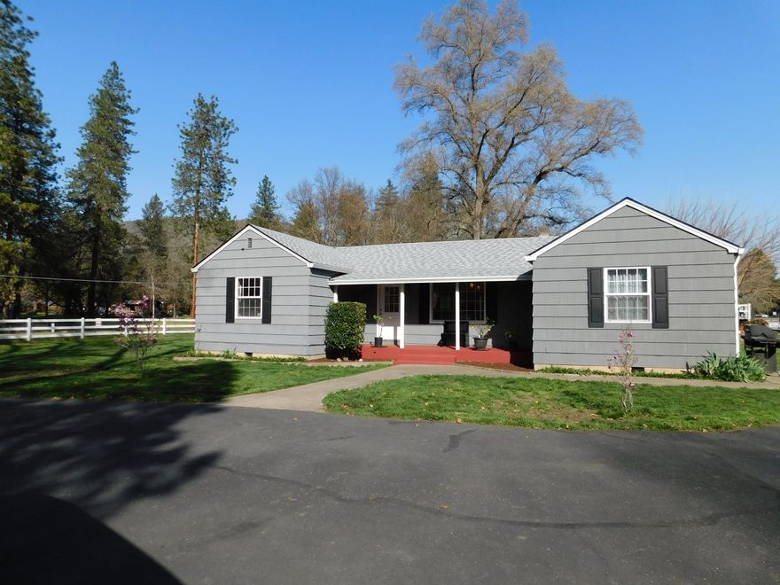 Paved, gated entry to 3.36 acres of flat, usable land, fenced and cross fenced.  Enjoy the mountain views from the freshly painted front porch or back deck of this 1506 sf, 3 bedroom, 2 bathroom home with a great layout, a beautiful updated kitchen with lots of counter space and a peninsula.  The living room and dining room feature a glass front, wood burning stove insert for added heat  and charm to keep you cozy and warm.  Three car garage, a workshop, a barn and even a treehouse, complete this package.  There are 2 wells and irrigation.  The owner's maintenance and care of this home shows!  Lots to offer at a great price!