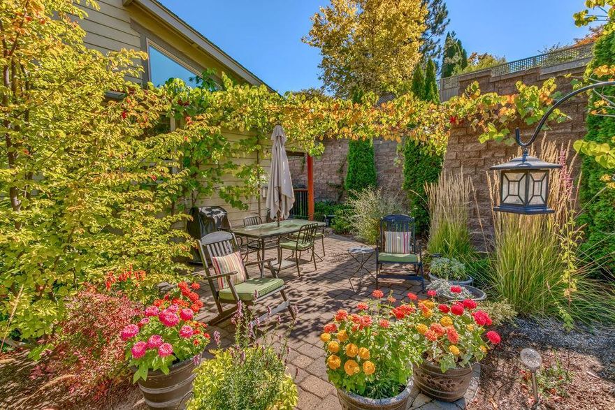 This lovely home, a large detached end-unit condo on a cul de sac, is surrounded by almost an acre of gardens and open space with paths and fountains. The home features beautiful Craftsman styling and high end finishes: Brazilian cherry floors downstairs; cork floors upstairs; solid wood doors, cabinets, and trim; granite countertops; vaulted great room with rock-faced gas fireplace, and HVAC's for each floor. Rooftop solar panels provide low to no-cost electricity. The oversized den has built-in bookcases and mountain views, perfect for the professional requiring a home office or as a bedroom. A huge vaulted master suite has mountain views, an oversized walk-in closet, and slate-tiled bathroom with large shower and soaking tub. Private back porch and patio border the HOA-maintained gardens and open space, perfect for entertaining. Large two-car garage and ample guest parking. Close to everything Ashland has to offer: downtown, OSF, Food Co-op and parks. Low HOA fees.