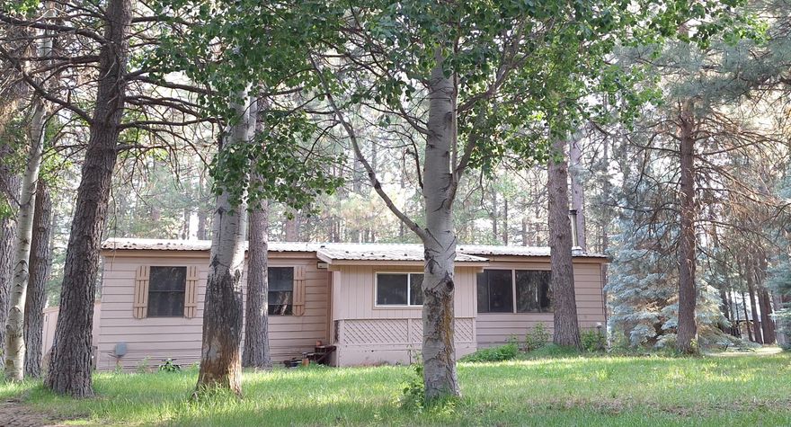 Enjoy the peaceful environment with this 2-bedroom 2-bathroom home with a large bonus room. Discover this vintage beauty, ready for your personal touch and updates. This home features updated appliances, a gas cooktop, wood stove, and an underground sprinkler system. This large lot has plenty of storage for your outdoor recreational toys, with three storage sheds and a workshop! The mature ponderosa pines make a park like setting and a small greenhouse is available to grow your own vegetables. Short distance to Deschutes National Forest Lands featuring lakes, rivers, and miles of roads to explore. There is so much potential for this home in beautiful Central Oregon!