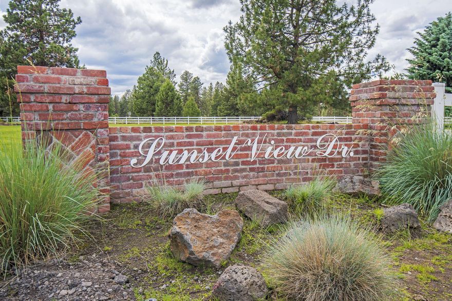 Original Sunset View Estate Lot, beautifully appointed single level home, huge RV barn/shop with additional hookups. Located on 2 1/2 acres, with exclusive access to adjacent 2 acres of common area for additional privacy. This home has it all, large kitchen island, top quality appliances, marble counters, knotty alder cabinets with soft close, new flooring, fresh paint, grand stone entry with double sided fireplace, timber accents, mahogany office, spacious primary bedroom with fireplace, 2nd primary has accessibility features, security system, super floor plan with triple car garage attached. The shop is magnificent, 14 ft overhead doors, 58 foot bay, 400 amp electrical service, heated, overhead fans, epoxy flooring, sink and laundry facilities, and private guest quarters; the grounds are meticulously maintained, mature landscape, pine trees, paved driveways, heated walkways, gazebo, water feature and a brand new pickle ball court! This property is a must see!!