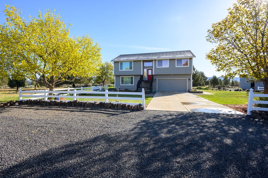 Panoramic Cascade & Eastern Butte views abound from this nicer than new home on a serene 4.78 acre corner lot just a few hundred feet from BLM access at the entrance to the Ranch, only 5 minutes from Terrebonne. The great room layout has unobstructed snow capped views from each window & the new carpet/laminate flooring compliment a beautifully upgraded kitchen w/granite counters, new stainless appliances, an island w/breakfast bar & access to a large private composite back deck. The primary is spacious & easily fits a king bed. Both upstairs bathrooms are fully remodeled. Downstairs there is a bonus room w/built in murphy bed, the 4th bedroom, a full bath, the utility room & access to the double garage. The home has a ductless heat pump system. The detached RV shop is 35x18 w/ 12x12 door and has 30 amp power w/lights & standard plugs. The shop is 36x48 & a portion is insulated w/ductless heat pump.  Carport dimensions are 24x40 & it has power/lights & one storage sheds is powered.