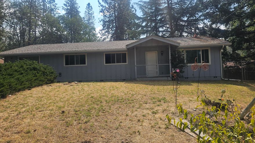 This open 1,740 sq. ft. home offers 3 bedrooms, 2 bathrooms, and a detached 2-car garage, all on a generous half-acre lot just minutes from town. The property features mature fruit trees and sweeping views overlooking the neighborhood, with a natural drainage area behind the home ensuring lasting privacy—no one can build directly behind you.

The spacious 528sq ft detached garage provides flexible options for parking, storage, or even the potential for an ADU (buyer to verify). The home itself has great bones and a spacious, single-level layout, ready for updates and personal touches. Offered as-is, this property is ideal for buyers looking for a fixer-upper with excellent potential to renovate or customize to their taste. With its desirable location, established lot, and solid design, it's a fantastic opportunity in Grants Pass.

Buyer to do their own due diligence.