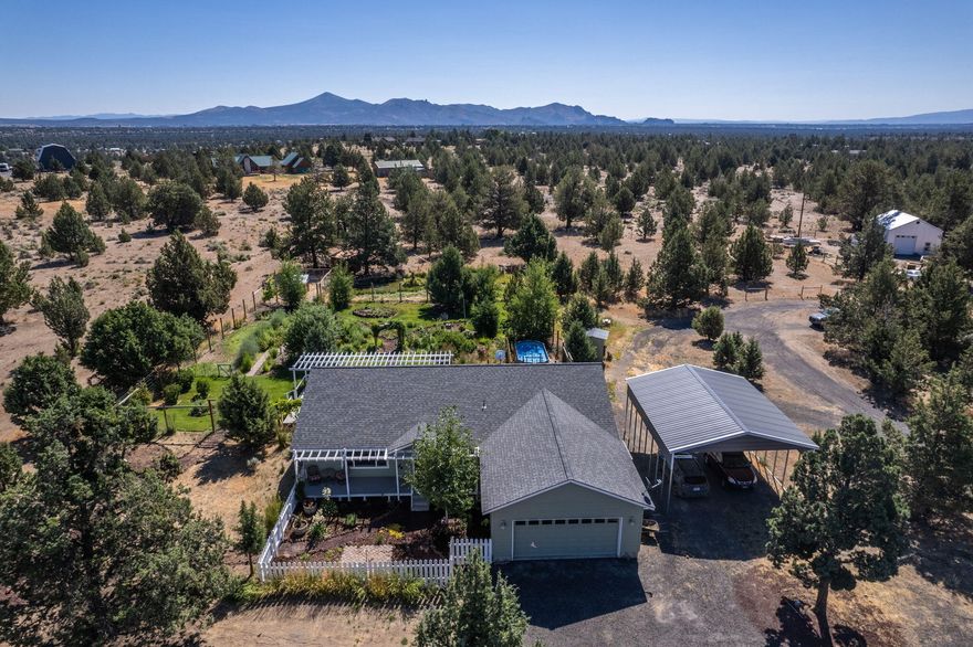 Oasis in the desert! Newer construction home boasts 1760 sqft of open living space. 3 br/2 ba on 5 private acres. Cascade Mountain Views from the covered front porch or from the couch! Vaulted ceilings over the window-lined great room lined. Kitchen has SS appliances pantry, island w/ bar top, and quartz counters! Large dining area. Primary bedroom features walk-in closet & step-in shower. 2 additional bedrooms could serve as home office and guest room. Entertain under the pergola on the spacious composite deck! Your guests will be in awe of stunning mature landscaping, w/ winding rock paths through lush green grass, under grapevines, around hops & sunflowers, & past the aspens. Deer-proof fenced garden area is ready for fall squash! Chicken coop and run. Rear pasture incl. a shelter for your hoofed friends and pond for feathered ones! RV carport for RV and/or boat storage! Still room for a shop or barn to suit! Join CRR to enjoy the pool, discounted golf, access to BLM, and MORE!