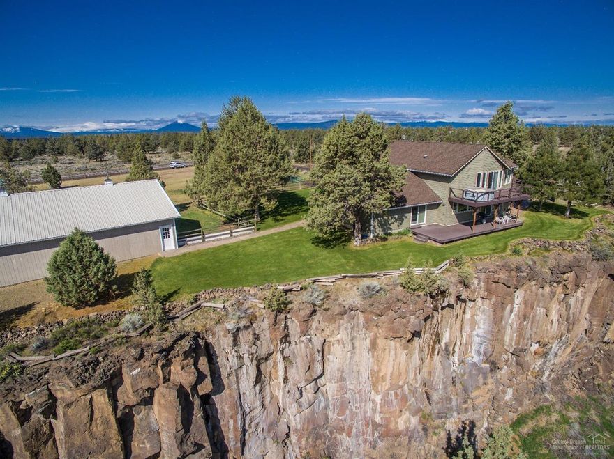 Rare find for Horse-Owners & golfers alike! This 6.7 acre rim property boasts a 4-stall lighted barn w/lighted 12x12 matted stalls. (2) 6ft sliding doors and 2 overhead doors, (1 RV Height door). Insulated & heated tack room w/hot/cold water. 2 lrg pastures & 2 heated auto-water stations. Room for hay/equipment/RV Storage. 20x30 cinder-block shop w/110/220V, man & overhead door. Insulated fruit room. 20x30 strg bldg. w/concrete floors. Lrg sliding doors & man door. 18-hole golf-course w/unlimited play