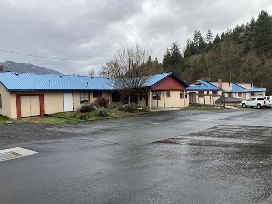 Endless Possibilities To Repurpose & Revitalize This Large Commercial Building On .89 Of An Acre With Hwy 395 Frontage! Located on Canyon Creek with great Canyon Mt Views, 7147 sq ft with second story of 704 sq ft, previous care facility with large kitchen and dining areas, extensive plumbing, diversity and architectural possibilities. This large building could be used for event spaces, offices, conference rooms, gallery, retail, eatery, education, storage units, living space or clinic programs, plenty of parking.  $345,000 #1135