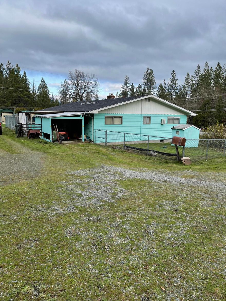 A desirable 1.25 acre lot close to town in Grants Pass! This home was built in 1965 and has 2004 sq ft. The 2 car garage was turned into a bonus room and is not included
in the square footage. The roof was replaced approximately 7 years ago. There is a 1 car garage, attached, and another 1 car garage, detached, with an RV carport
complete with utility connections. and workshop. Yard is fenced in around home to secure pets and there is another fenced area that was once used to accommodate
horses. Bring offers quickly, priced to sell and won't last long!