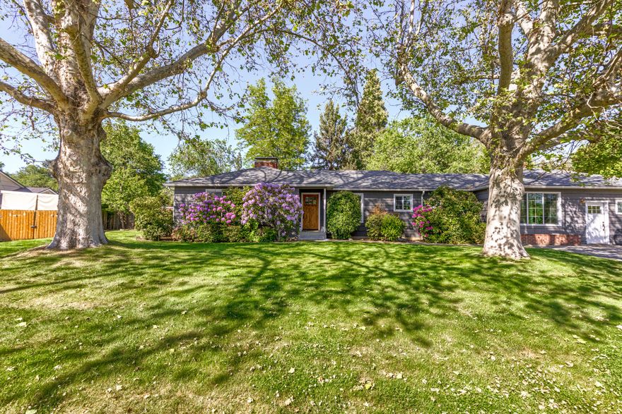 Potential in-law or two-family set-up in this lovely old east Medford home built in 1950.  Situated on a large 1/3-acre lot, you'll enjoy the huge backyard (sitting under an updated pergola) that is forested with large mature cedar trees and assorted plants. The interior of the home welcomes you with well cared for hardwood floors, spacious living & family rooms and an updated kitchen. The garage was converted to an ADU in about 2016 with a bedroom and full bath and boasts its own entrance & mini-split HVAC system. The interior of the home was painted in 2019. All windows are newer vinyl and have had the trim paint and caulking refreshed. The kitchen enjoys granite counters, white painted cabinets and gas range with stainless appliances. This home has been very well maintained and is ready for the new owner to continue the care. This location affords easy access to much of Medford for schools, shopping and medical. Call today for an easy appointment.