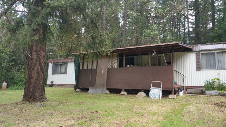 Property must be sold in As-Is condition. Nice 2.67 acres with a 77' double wide manufactured home. Several out buildings for storage. Owner may carry 1st Trust Deed with adequate down payment and with terms and conditions. Owners have lived on the property for 30+ years. All information is deemed reliable but not verified. Anyone considering purchasing this property should perform their own investigation into the uses and condition of the property.