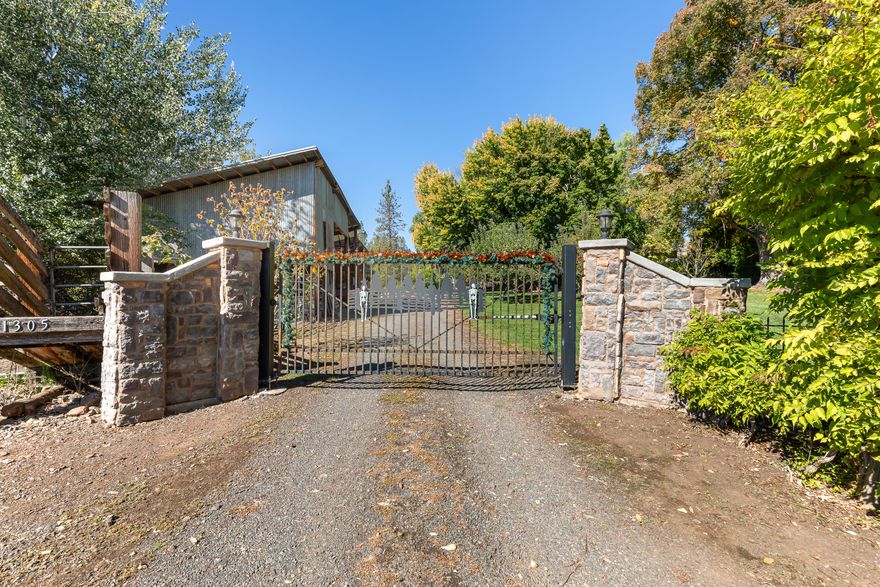 Amazing Horse Property! 6.9 irrigated acres, EFU, low property taxes! Great flood irrigated pasture, 2+ stall barn, spacious tack room, bonus storage & round pen. 3 bed, 2 bath home conveniently located just minutes from town, providing easy access to schools, shopping, golf courses and wineries. Set well back from the road the property is fenced, private and beautifully treed with security gate. Beautifully updated kitchen with ss appliances, granite countertops and spacious eating area. Warm and welcoming living room with French doors leading to an expansive deck with 2 sitting areas. Primary suite with double closets, dual sink vanity and built-in storage. Updated guest bath with a new shower, jetted tub and quartz countertops. Chicken coop, fruit trees and a beautiful garden area with deer fencing and raised beds. Oversized 2-car garage with storage, RV parking area, and a bonus craft room or potential office space. Saddle up and experience this immaculate horse property!