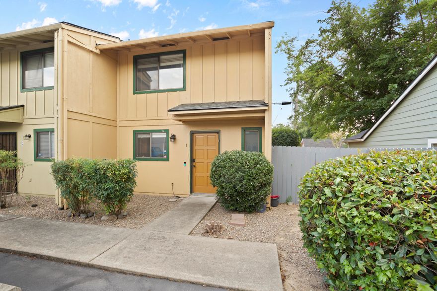 Don't miss this end unit condo with two parking spaces right out front! The kitchen flows into a spacious dining and living area, with a side window that brings in extra natural light and direct access to the patio. Laminate flooring runs throughout the main level, with carpet on the stairs for comfort. Upstairs, the primary bedroom features its own balcony and walk in closet. Main bathroom includes tile floors, a shower/tub combo, and an updated sink and counter. Recent upgrades include a newer roof, water heater, and fence! Outside, enjoy your private fenced backyard and patio!