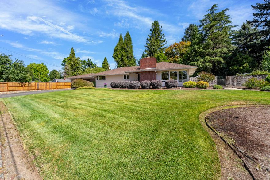 First time on the market—original owner! Rare half-acre property with shop, RV parking, and landscaped—all within Grants Pass city limits. Located at the end of a quiet, dead-end street, this well-maintained 3-bedroom, 2-bath home features updated vinyl windows, granite kitchen counters, oversized bedrooms, and both formal and informal dining areas. Enjoy a spacious layout filled with natural light, a large laundry/mudroom with built-in cabinetry, and a cozy fireplace. The level, landscaped lot includes an 816 sq ft detached shop, carport, RV pad with power hookup, a basketball half-court, and full irrigation. Connected to city sewer and served by a private well. Zoned R-1-8 with no HOA. Just minutes to shopping, schools, medical, and downtown.