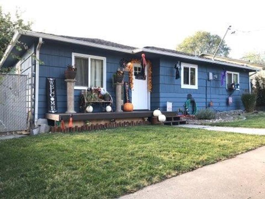 Adorable 3 bedroom, 2 bath home with 1296 sq ft of open living space. This would be a great rental or first home. Master bedroom is separate from the other two rooms. Newer paint, front porch, fence, retaining wall, roof and more. Backyard is a nice size with alley access.