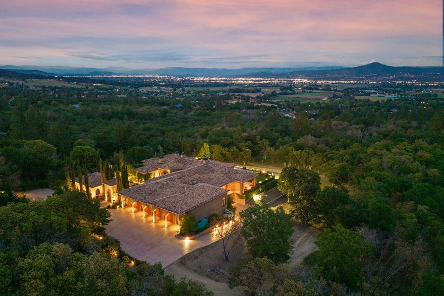 Masterpiece of Art in Southern Oregon, 1st time on the market! Overlooking Jacksonville Mts and City lights! Private park-like 5 acres w/city water! Mediterranean/Old world style w/stone gated entry. 12 car garage. 9904 SQ FT of luxury. Attention to details throughout this amazing property. 4 primary suites, 6 baths, Pebble tec pool and spa, covered patios w/stone fireplace, gated courtyard w/large fountain and guest Casita! Fall in love; 13' double door entry that takes you into a grand great room w/many 9' French doors opening to the outdoor living room, 8 fireplaces and dome ceilings. Large stone fireplace in kitchen/breakfast room. Beautiful kitchen that any chef would love w/butler pantry and catering area w/third sink and wine fridge. Primary suites w/custom tall ceilings. Tuscan Villa with a 12 car garage, elegant formal dining rm with built-ins. Downstairs family, theater and exercise rms. Built & architecturally designed by Mike Pagnini a premier builder in Southern Oregon.