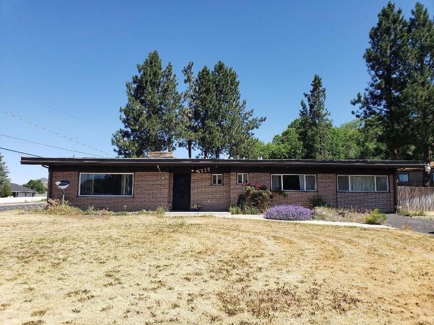 Come take a look at this beautiful 3 bedroom, 2 full baths one of the baths has a walk-in/wheel chair accessible shower. Large bonus room. High beamed ceilings with wood accents throughout the home. Kitchen opens into family/dining rooms. Double sided fireplace with inserts. Newer carpeting and laminate flooring along with a coat of fresh paint. Gas furnace with air conditioning. Fenced back yard. Sprinkler system in front and back. Covered parking with bonus storage shed with sliding doors. Covered patio off carport. 2 driveways provide additional parking.