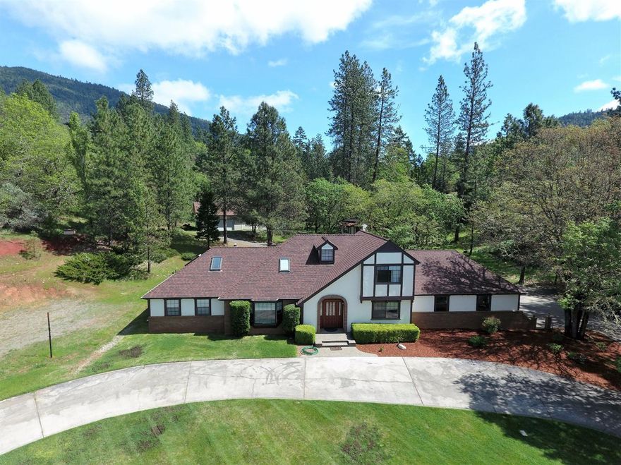 Majestic Beauty awaits you with this Tudor home with all the modern amenities and more! Located in the desirable Colonial Valley is this custom built Tudor that has a large oversize workshop and detached studio room. Paved circular driveway greets you to your retreat. Elegant master bedroom w/walk-in closet and large bathroom w/heated tile floor. Large living room that expands into the kitchen w/newer appliances. The garage is off the side of the house w/much more parking for guests. Upstairs is 3 more bedrooms, one of which is oversize and could be guest qtrs. Covered patio in back that leads up to the workshop or storage area. Trees, lush green manicured lawn and serenity abound in the Colonial Beauty. Too much to list so schedule your showing on this one of a kind home in North Grants Pass today! All info deemed accurate but not verified or guaranteed. Buyer to perform all their own due diligence